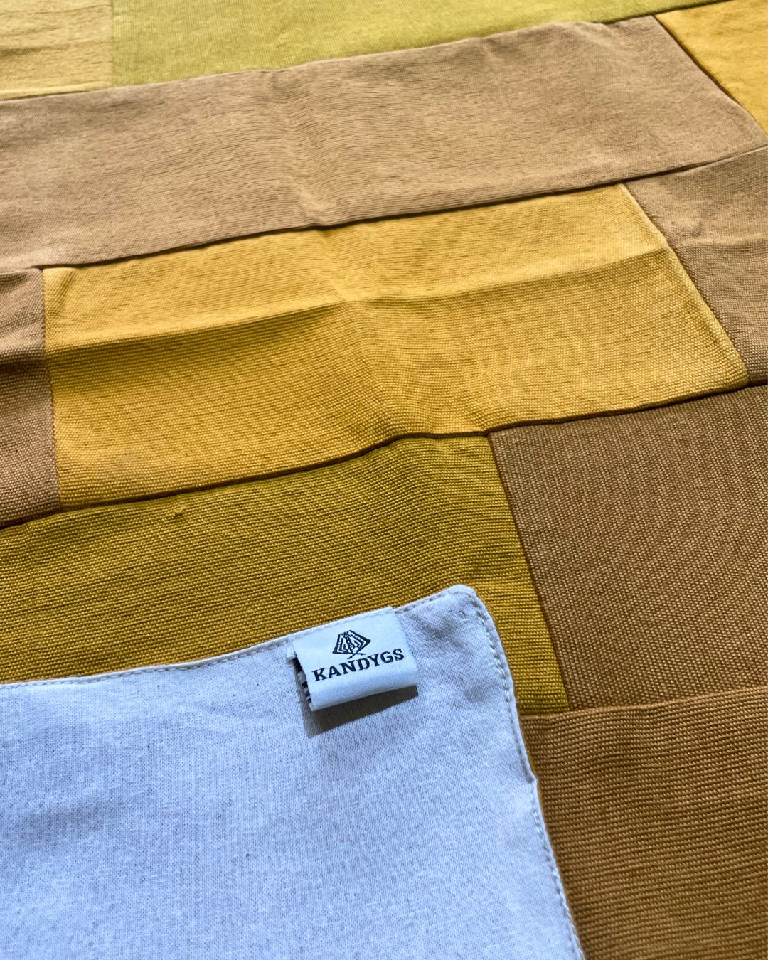Textile with a Kandygs label on a multicolored fabric background