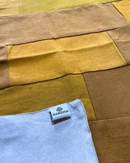 Textile with a Kandygs label on a multicolored fabric background